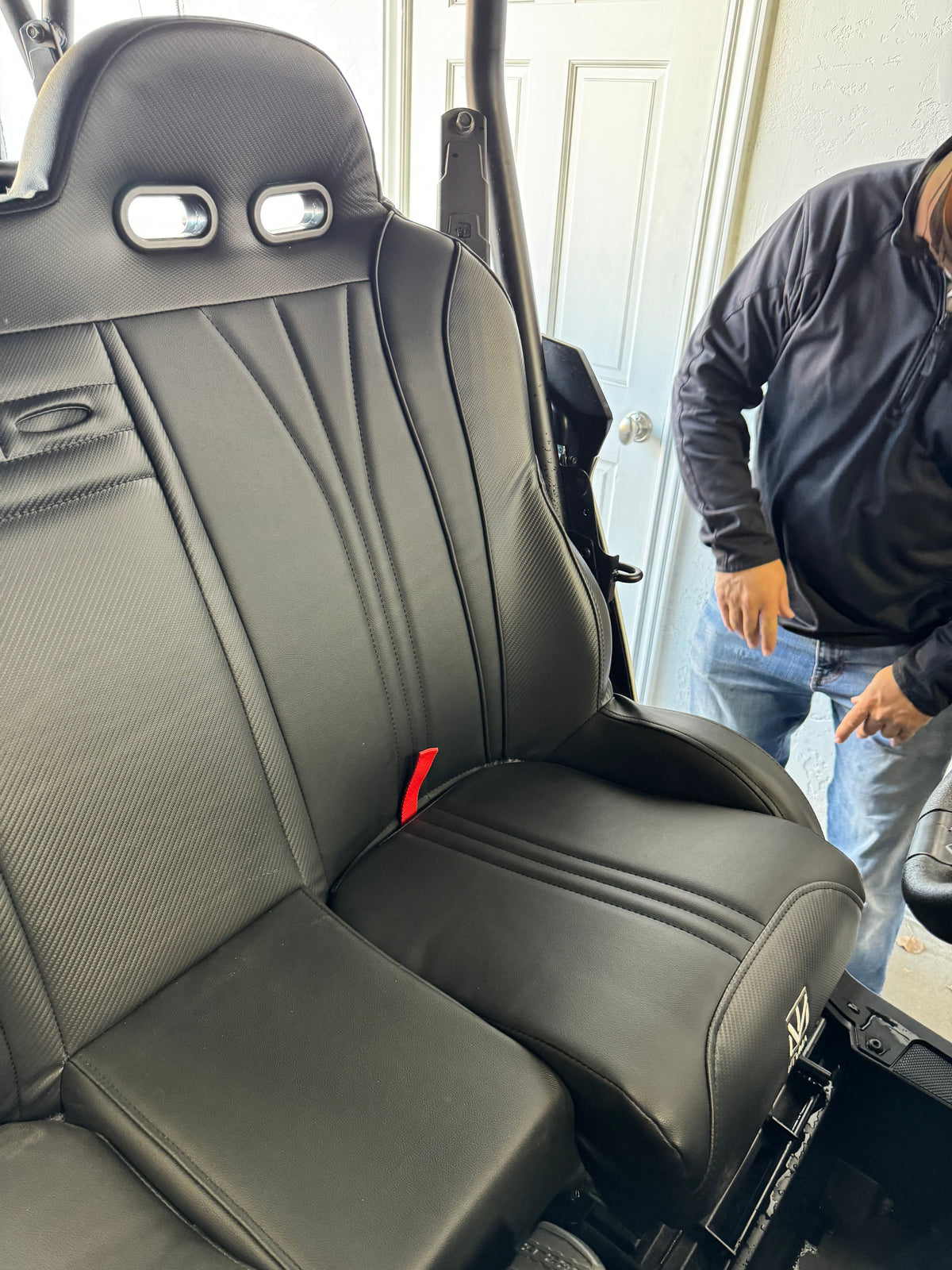 Close view of a black bench seat installed in a side-by-side