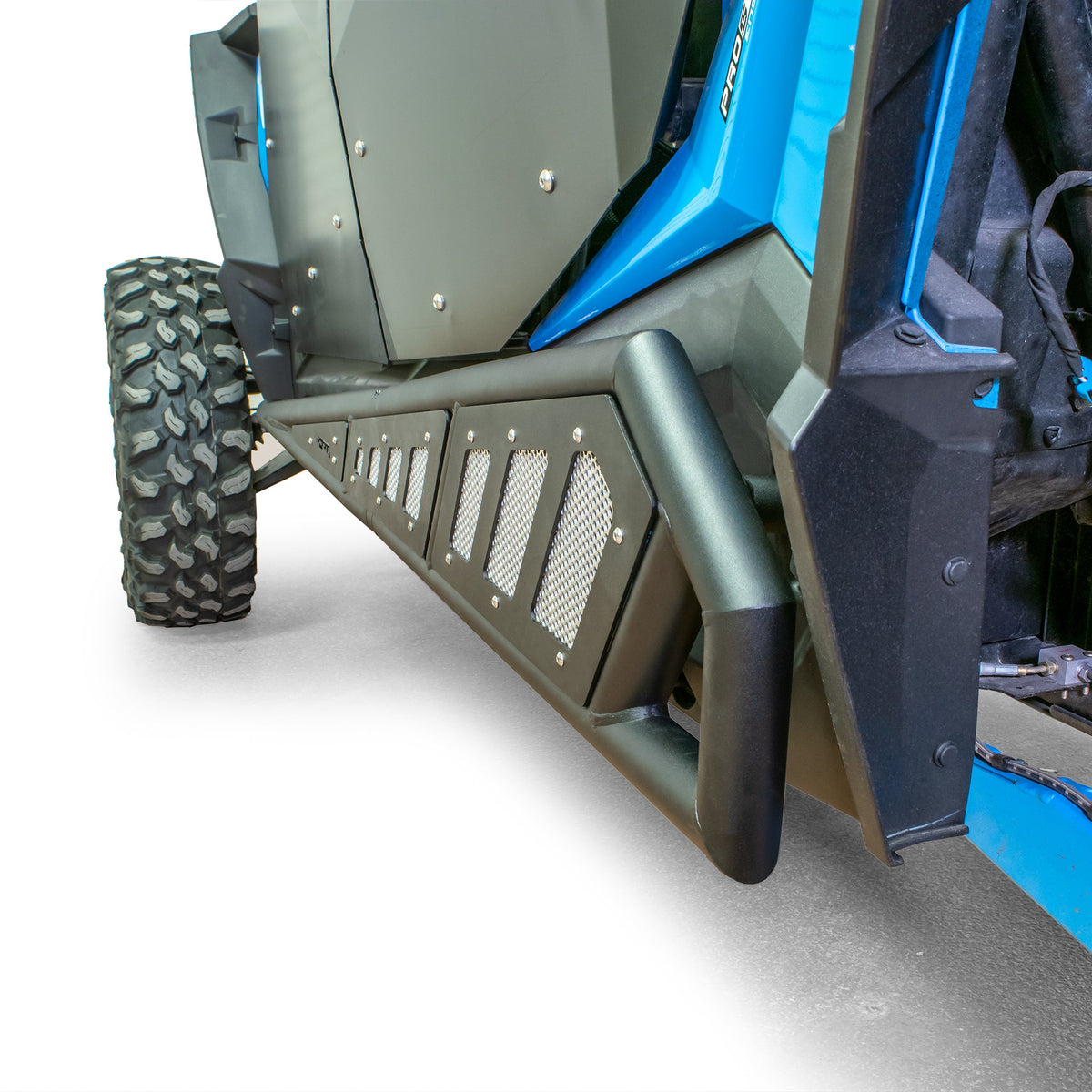 Close-up of DRT four-door rock sliders installed on a Polaris RZR XP 4, showing the rear end of the slider below the door.