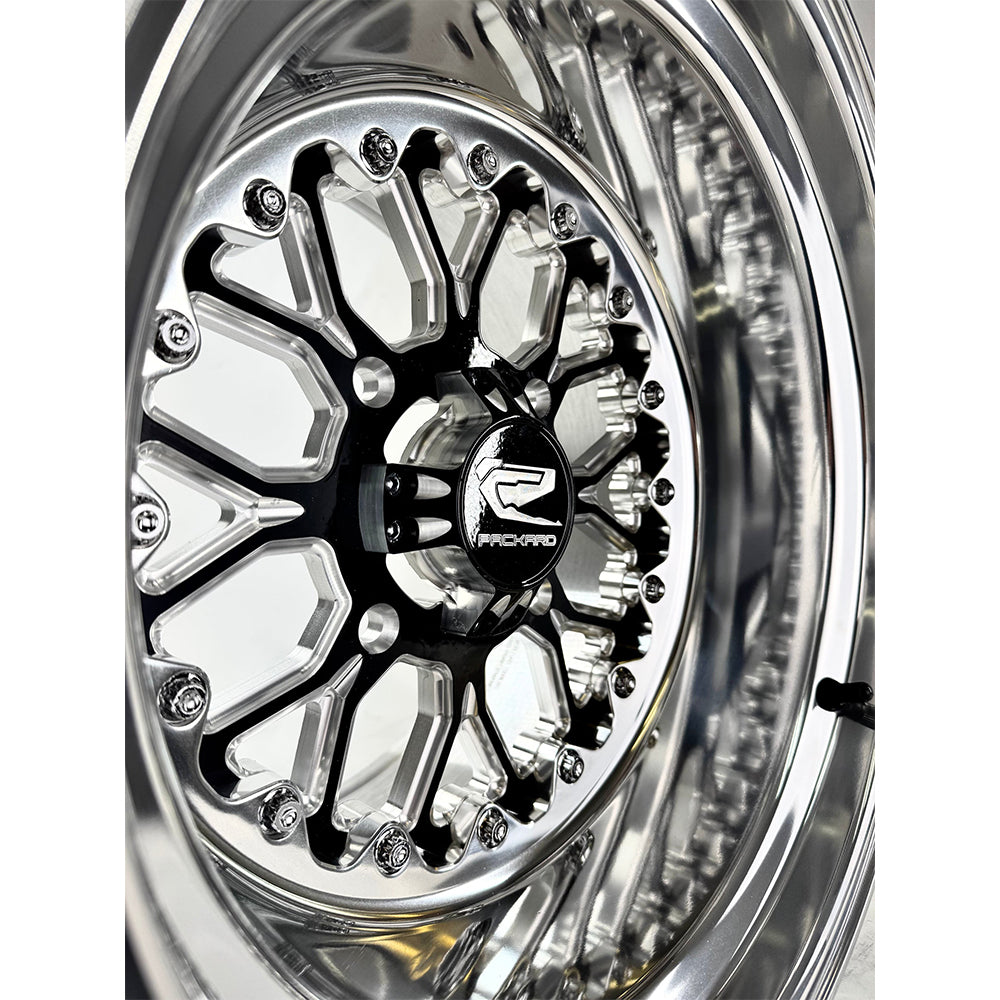 Close-up of a Packard Wishbone gloss black non-beadlock UTV wheel with a polished barrel.