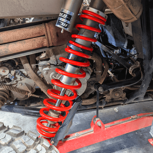 Red tender springs installed on a 2014-2018 Polaris RZR XP 1000 rear shock collection