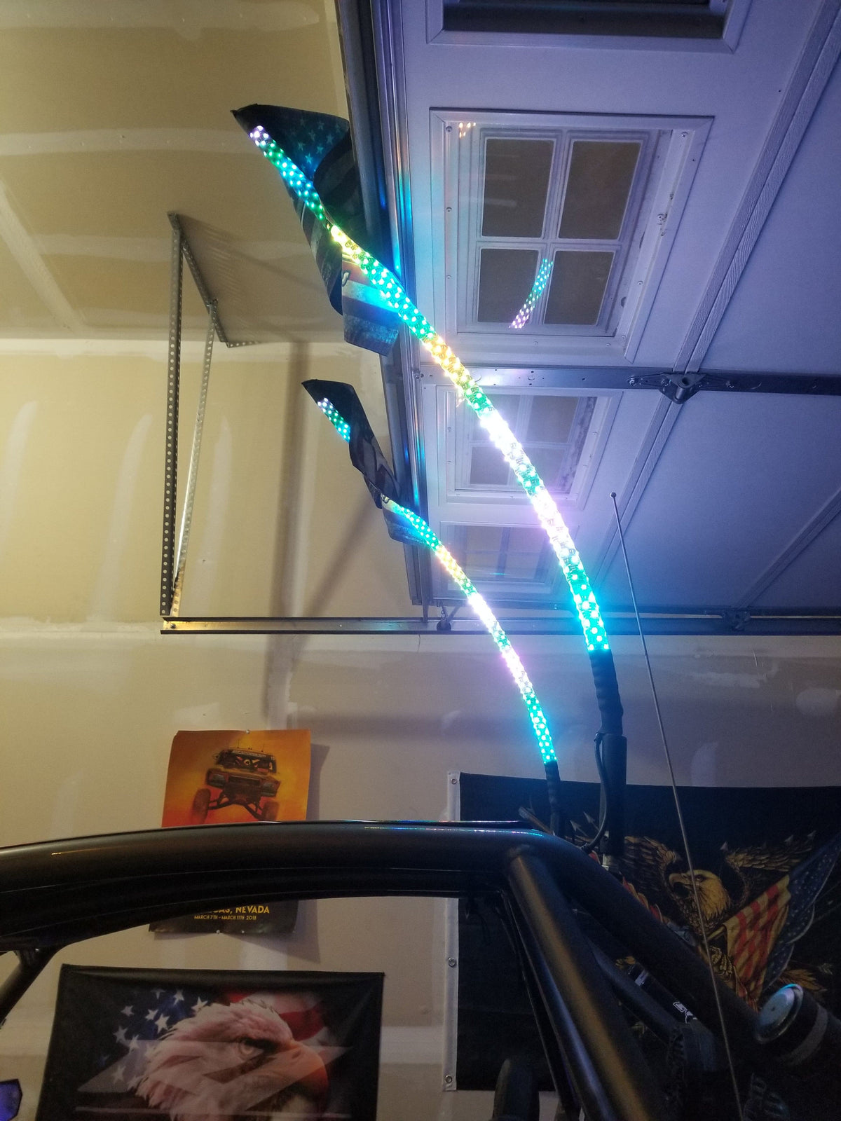 R1 LED whip lights illuminated on a UTV at night