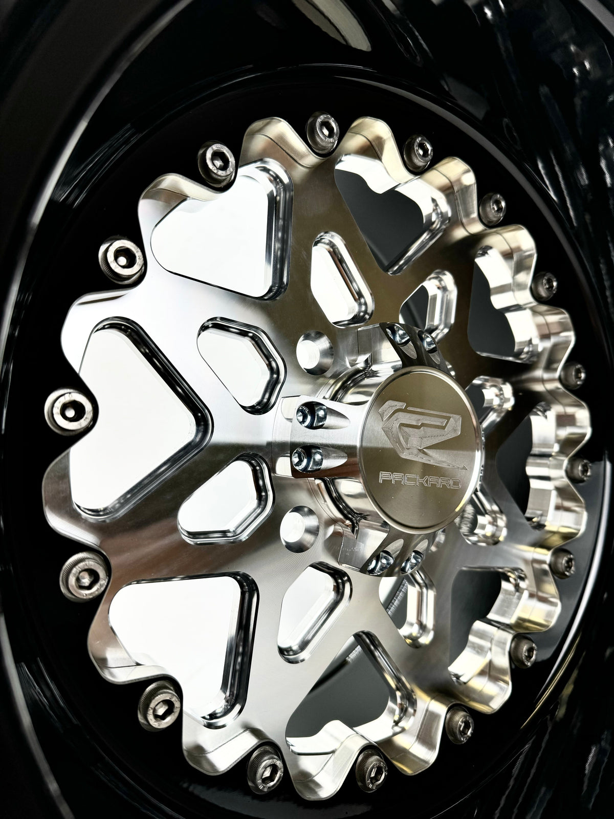 Close-up of a Packard V2 Super Star silver non-beadlock UTV wheel with a black barrel.
