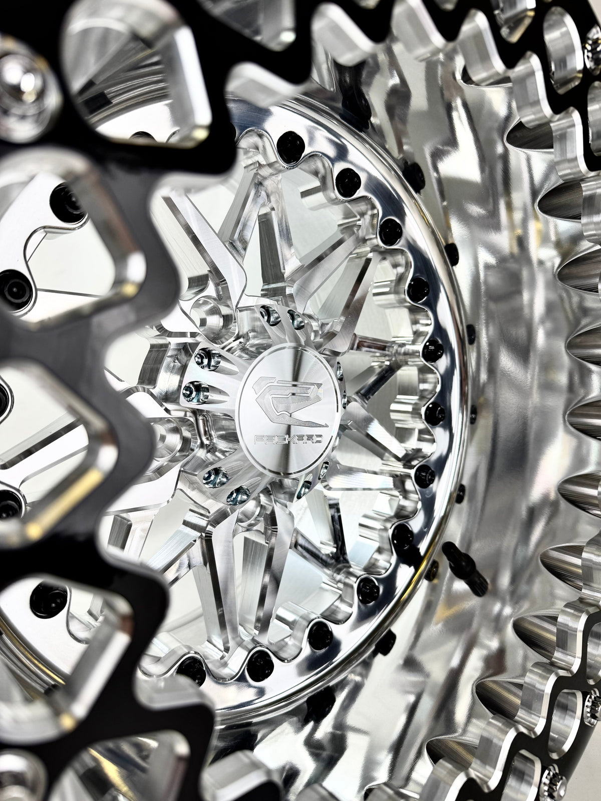 Close-up of a Packard Impact silver beadlock UTV wheel with a polished barrel.