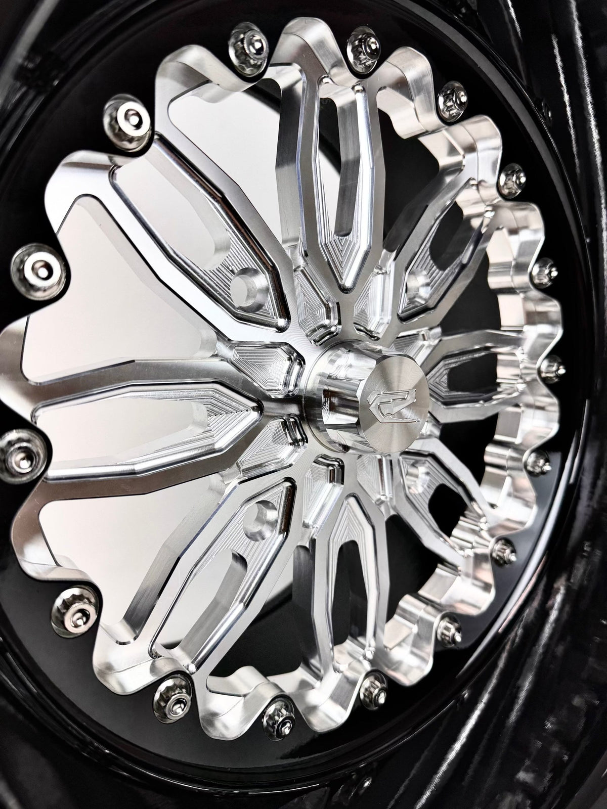 Close-up of a Packard Icon silver non-beadlock UTV wheel with a black barrel.