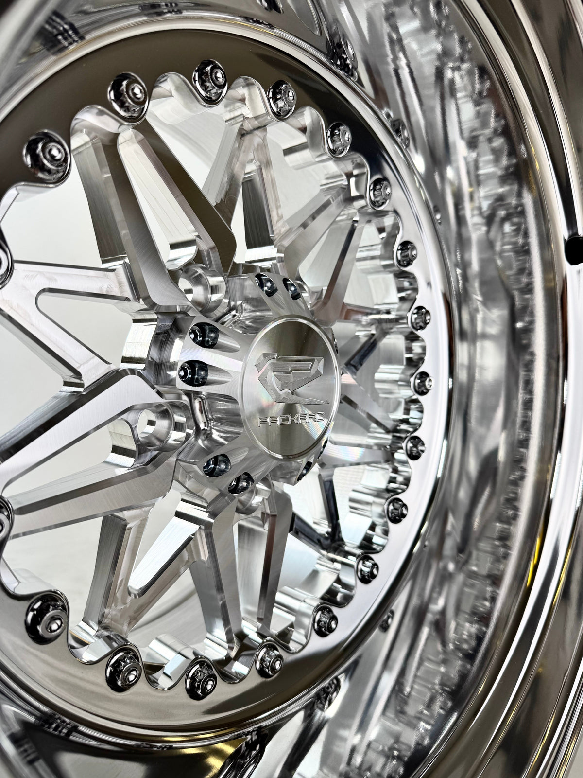 Close-up of a Packard Impact 2.0 silver non-beadlock UTV wheel with a polished barrel.