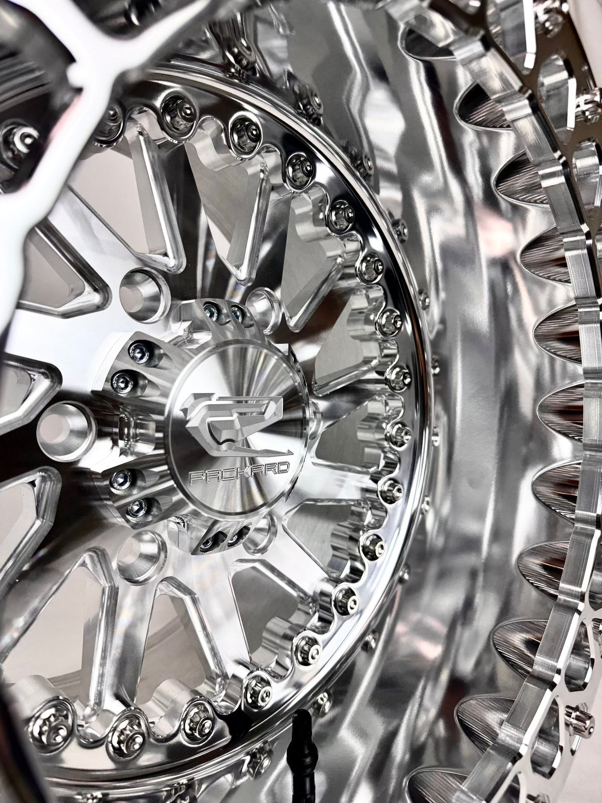 Close-up of a Packard Cyclone silver beadlock UTV wheel with a polished barrel.