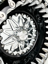Close-up of a Packard Impact silver beadlock UTV wheel with a black barrel.