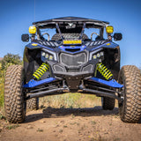 DRT aluminum front grille installed on a blue Can-Am Maverick X3, full front trail view