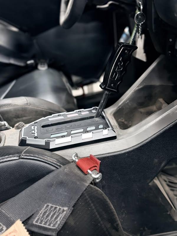 DRT Pro Series shifter gate and Grip Shifter V2.0 installed together in a Polaris RZR center console on an Addiction Powersports customer build; products sold separately.