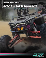 DRT x Shreddy front grille installed on a 2022–2024 Polaris RZR Pro R/Turbo R build in action; custom pink finish and other accessories shown.