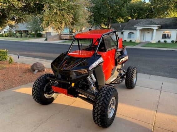 Red Polaris RZR RS1 equipped with HCR rear trailing arms