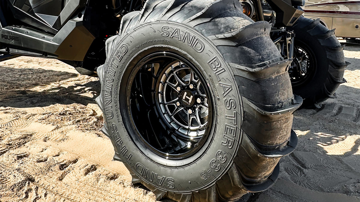 Hostile HF22 Rival installed rear-wheel detail with a sand paddle tire on a Polaris RZR Pro R. Hostile gallery.