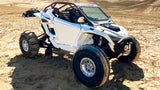 Hostile HF32 Rival Beadlock polished wheels installed on a white Polaris RZR Pro R in the dunes. Hostile gallery photo.
