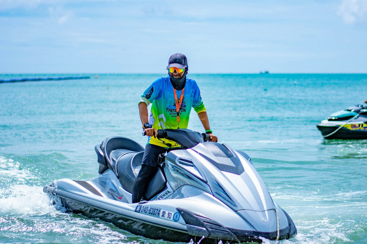 Rider on a silver personal watercraft on blue water