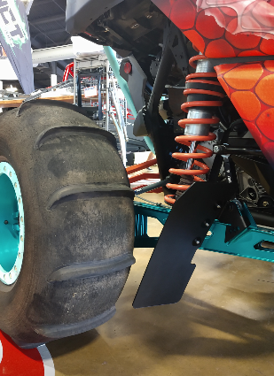 HCR trailing arm mud flap beside a rear tire