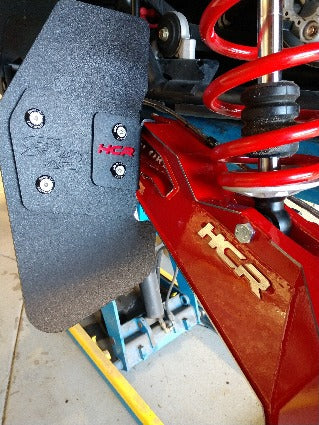 HCR trailing arm mud flap installed beside a Polaris RZR rear suspension