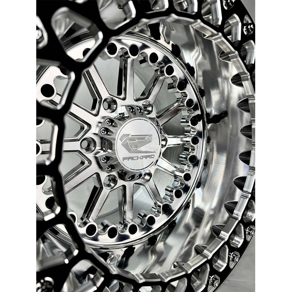 Close-up of a Packard Element silver beadlock UTV wheel with a polished barrel.