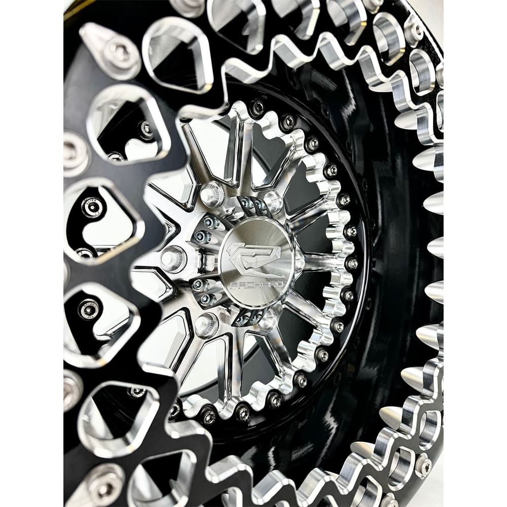 Close-up of a Packard Element silver beadlock UTV wheel with a black barrel.
