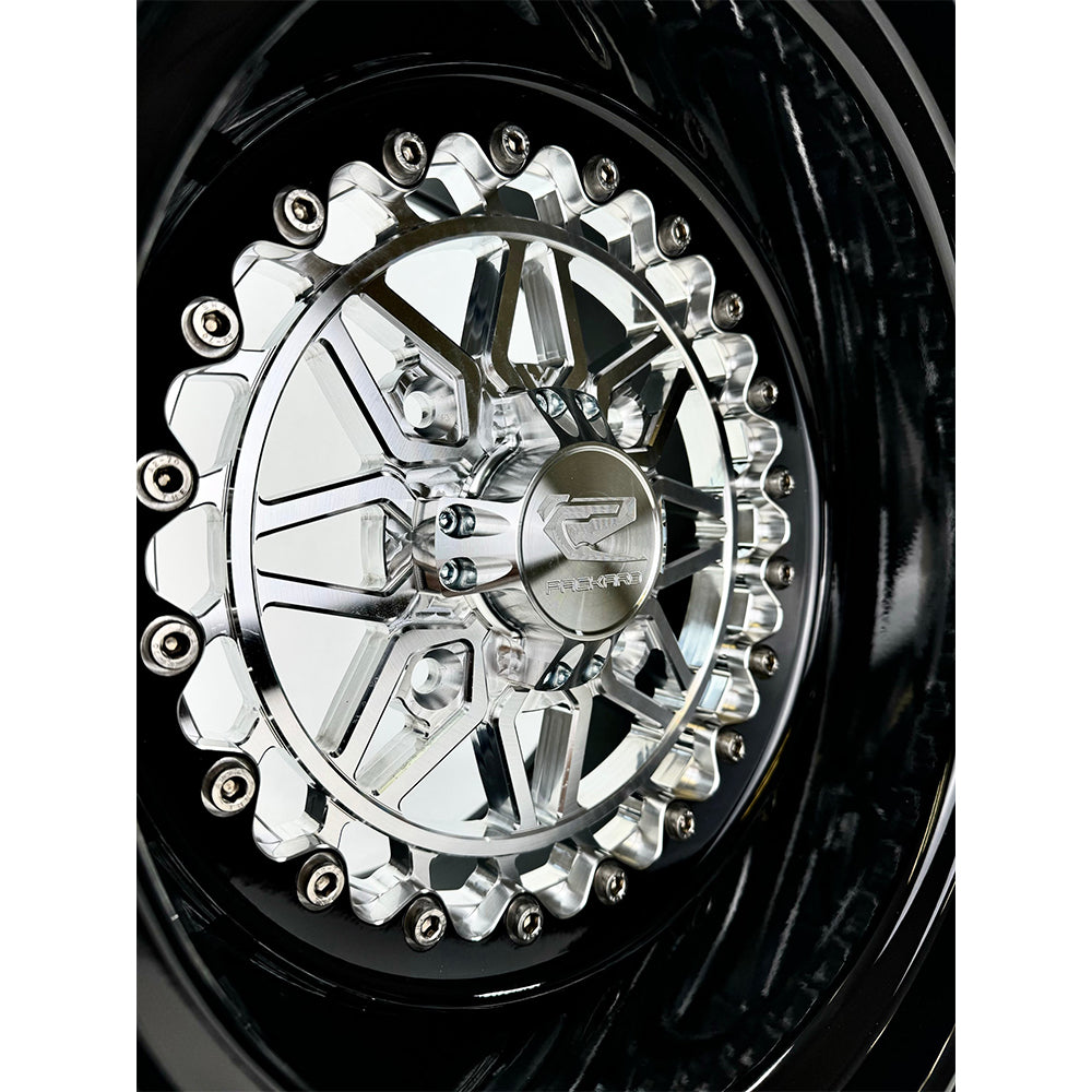 Close-up of a Packard Apollo silver non-beadlock UTV wheel with a black barrel.