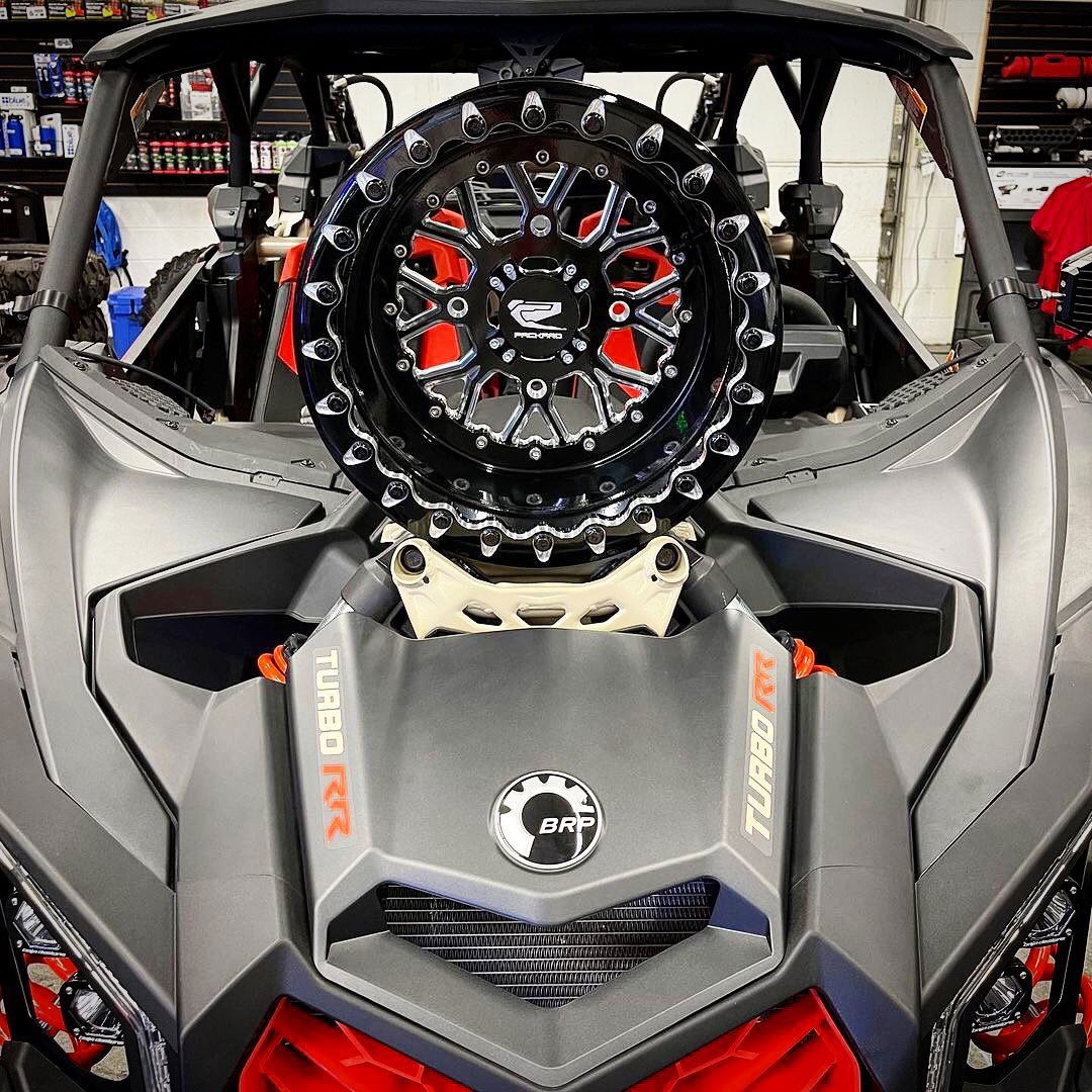Packard Wishbone gloss black beadlock wheel with machined accents displayed on a Can-Am Maverick X3.
