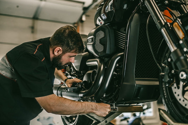 Street bike mechanic servicing a motorcycle