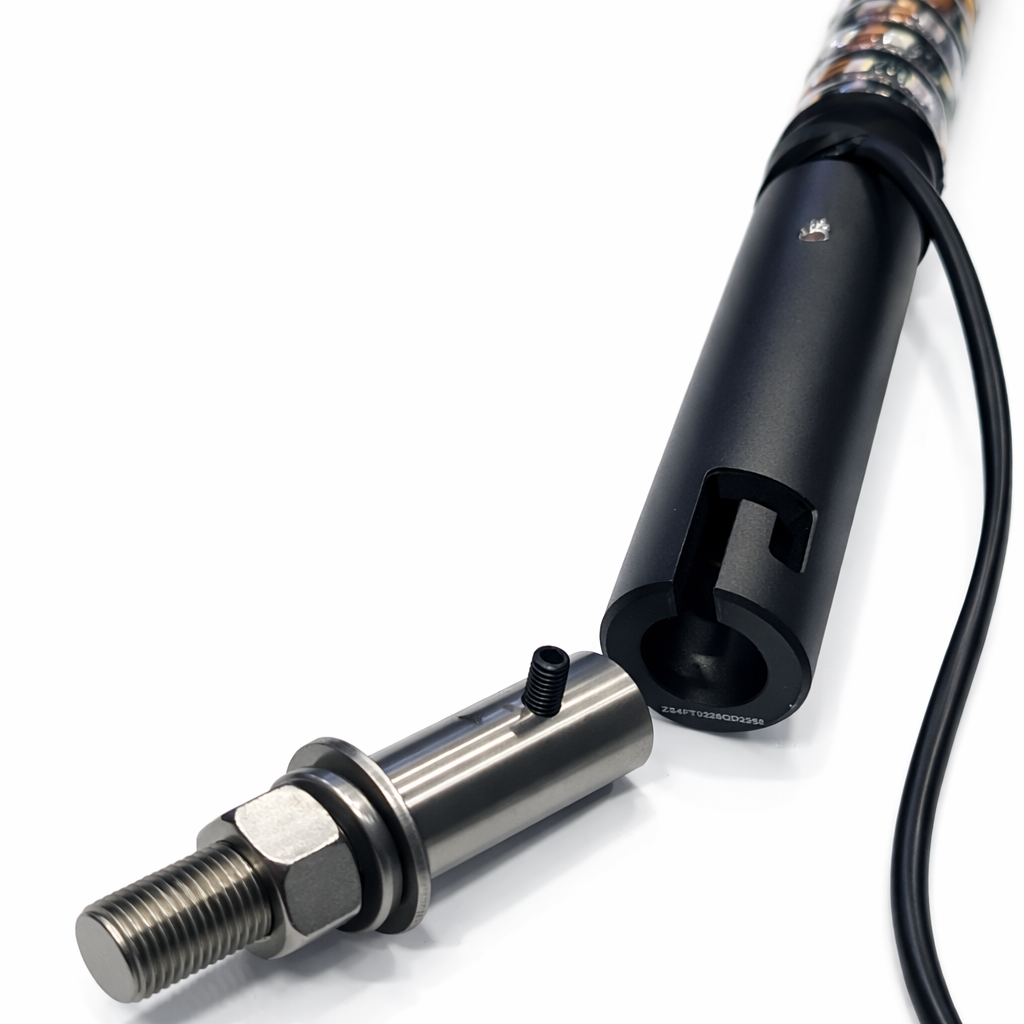 Close-up of a mechanical component with a black cable on a white background